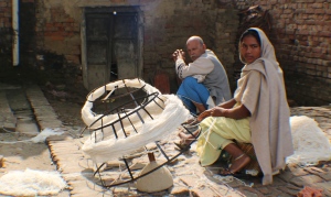 The carpet industry supply chain in action:  villagers throughout Bhadohi work at home weaving, carding and spinning wool.